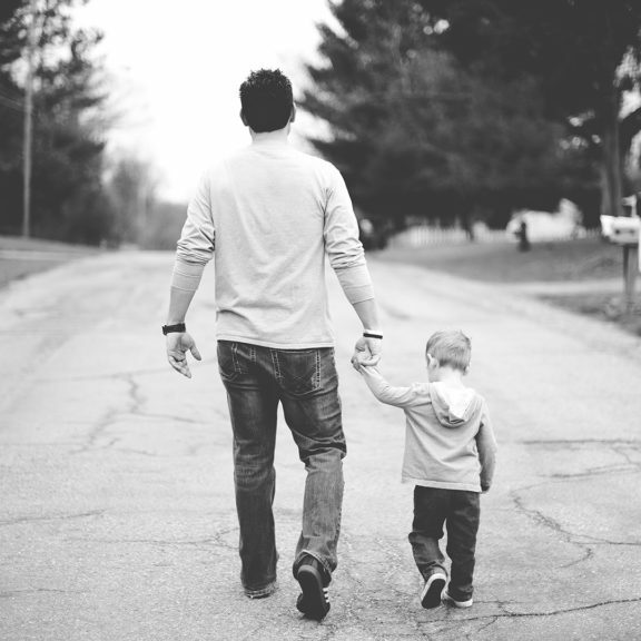 Dad and son walking down the road